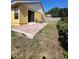 Exterior shot of the backyard featuring a patio with outdoor seating and sparse landscaping at 7228 Spring Villas Cir, Orlando, FL 32819