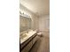 Well-lit bathroom featuring a single sink vanity and a shower-tub combo at 7228 Spring Villas Cir, Orlando, FL 32819