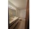 Well-lit bathroom with a vanity, toilet, and a bathtub with white textured tiling at 7228 Spring Villas Cir, Orlando, FL 32819