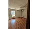 Bedroom featuring wood floors, a ceiling fan, and a window providing lots of natural light at 7228 Spring Villas Cir, Orlando, FL 32819
