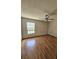 Bedroom featuring a window with blinds, wood floors, and a ceiling fan at 7228 Spring Villas Cir, Orlando, FL 32819