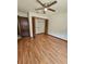 Bright bedroom features wood floors, ceiling fan, and a spacious closet with doors ajar at 7228 Spring Villas Cir, Orlando, FL 32819
