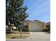 Charming single-Gathering home featuring a two-car garage, well-maintained lawn, and mature tree at 7228 Spring Villas Cir, Orlando, FL 32819