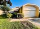 Charming single-Gathering home with a well-maintained front yard, a two-car garage, and lush landscaping at 7228 Spring Villas Cir, Orlando, FL 32819