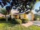Inviting single-Gathering home with a well-manicured lawn, complemented by mature shade trees and lush greenery at 7228 Spring Villas Cir, Orlando, FL 32819