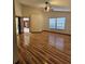 Open living room featuring wood floors, ceiling fan, and double windows offering great natural light at 7228 Spring Villas Cir, Orlando, FL 32819