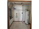 Utility room featuring a water heater, tiled floors, and space for storage at 7228 Spring Villas Cir, Orlando, FL 32819