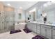 Elegant bathroom with double vanity, soaking tub, glass shower, and walk-in closet access at 7873 Dausset St, Orlando, FL 32827