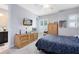Bedroom with gray walls, ceiling fan, wood dresser, blue bedding, and window with shutters at 7873 Dausset St, Orlando, FL 32827