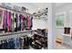 Spacious walk-in closet with custom shelving, hanging rods, and shoe racks at 7873 Dausset St, Orlando, FL 32827