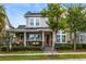 Charming two-story home featuring a cozy front porch, stone accents, solar panels, and well-maintained landscaping at 7873 Dausset St, Orlando, FL 32827