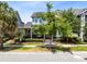 Charming home featuring a welcoming front porch, landscaped garden, and inviting curb appeal at 7873 Dausset St, Orlando, FL 32827