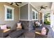 Comfortable front porch with ample seating, ceiling fans, and stylish decor at 7873 Dausset St, Orlando, FL 32827