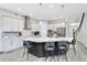 Modern kitchen featuring a large center island, granite countertops, stainless steel appliances, and stylish pendant lighting at 7873 Dausset St, Orlando, FL 32827