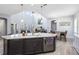 Spacious open-concept kitchen with a large island, stainless steel appliances, and views to the living and dining areas at 7873 Dausset St, Orlando, FL 32827