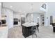 Bright kitchen with a large island, stainless steel appliances, and seamless flow to the staircase and other living areas at 7873 Dausset St, Orlando, FL 32827