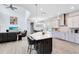 Open-concept kitchen with a large island, stainless steel hood, and seamless flow into the living area at 7873 Dausset St, Orlando, FL 32827