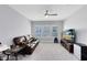 Relaxing living room with comfortable sofa, ceiling fan, and a view of the backyard at 7873 Dausset St, Orlando, FL 32827
