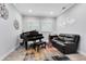 Cozy living room featuring a grand piano, leather sofa, and recessed lighting at 7873 Dausset St, Orlando, FL 32827
