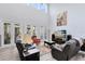 Bright living room with high ceilings, lots of natural light, stylish decor, and seamless flow to the outdoor patio at 7873 Dausset St, Orlando, FL 32827