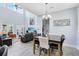 Open-concept living and dining areas with high ceilings, modern decor, and an abundance of natural light at 7873 Dausset St, Orlando, FL 32827