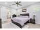Relaxing main bedroom featuring a ceiling fan, ensuite bathroom access, and a soothing color palette at 7873 Dausset St, Orlando, FL 32827