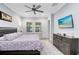 Serene main bedroom with large windows, ceiling fan, and stylish decor, creating a relaxing retreat at 7873 Dausset St, Orlando, FL 32827
