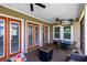 Covered patio with outdoor seating, ceiling fan and television for comfortable outdoor living at 7873 Dausset St, Orlando, FL 32827