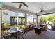 Screened patio with dining and sitting area, ceiling fans, pavers, outdoor kitchen at 7873 Dausset St, Orlando, FL 32827
