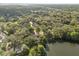 Aerial view of the neighborhood with mature tree coverage and a lake nearby at 100 Kennison Dr, Orlando, FL 32801
