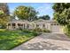 Beautiful home featuring a well-manicured front yard, a circular front door, and a long driveway at 100 Kennison Dr, Orlando, FL 32801
