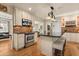 Spacious kitchen with stainless steel appliances, a center island with seating, and designer pendant lighting at 100 Kennison Dr, Orlando, FL 32801