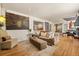 A bright living room with hardwood floors, a stylish sofa, and seamless open floor plan to kitchen at 100 Kennison Dr, Orlando, FL 32801