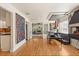Open living room with hardwood floors, modern art, and seamless flow into other living spaces at 100 Kennison Dr, Orlando, FL 32801