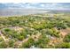 Scenic aerial view of a property surrounded by lush greenery and trees near the water at 101 W Oakland Ave, Oakland, FL 34760