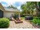 Backyard features a stone patio, fire pit, Adirondack chairs, and a hot tub at 101 W Oakland Ave, Oakland, FL 34760