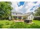 A spacious backyard featuring a patio, a fire pit, a jacuzzi, and lush green grass at 101 W Oakland Ave, Oakland, FL 34760