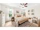 Comfortable bedroom with a ceiling fan, and two large windows providing natural light at 101 W Oakland Ave, Oakland, FL 34760