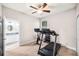 Bedroom with exercise equipment and access to a bathroom at 101 W Oakland Ave, Oakland, FL 34760