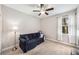 Bright bedroom featuring a sofa, ceiling fan, and a window with natural light at 101 W Oakland Ave, Oakland, FL 34760