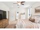 Spacious bedroom featuring a ceiling fan, carpeted floors, and access to other rooms at 101 W Oakland Ave, Oakland, FL 34760