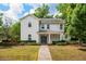 Charming two-story home featuring a landscaped front yard and inviting front porch at 101 W Oakland Ave, Oakland, FL 34760