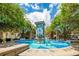 Beautiful decorative fountain in the city park surrounded by lush greenery and blue sky at 101 W Oakland Ave, Oakland, FL 34760