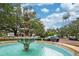 Picturesque fountain in a town square with lush greenery and a water tower backdrop at 101 W Oakland Ave, Oakland, FL 34760