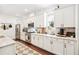 Well-lit kitchen boasting stainless steel appliances, white cabinets, and marble countertops at 101 W Oakland Ave, Oakland, FL 34760
