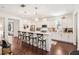 Bright kitchen featuring an island with bar stool seating and stylish pendant lighting at 101 W Oakland Ave, Oakland, FL 34760