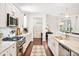 Stylish kitchen with stainless steel appliances, stone countertops, and white cabinets at 101 W Oakland Ave, Oakland, FL 34760