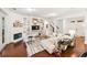 Open living space with custom built-ins, a fireplace, and an adjacent staircase at 101 W Oakland Ave, Oakland, FL 34760