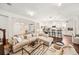 Inviting living room with a large sectional sofa and open access to the kitchen with bar seating at 101 W Oakland Ave, Oakland, FL 34760