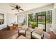 The outdoor patio has a ceiling fan, seating, and a table for entertaining at 101 W Oakland Ave, Oakland, FL 34760